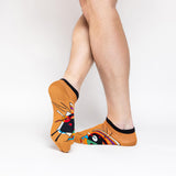 Colorful socks with abstract Kandinsky design worn by a person on a white background