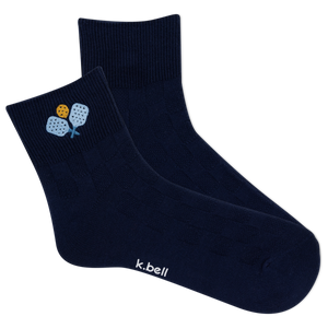 Pair of navy blue socks with a small design and 'k.bell' branding on a white background
