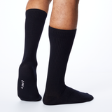 Back profile of a man wearing black Dr. Scholl's crew socks.