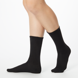 Side profile of a woman wearing black Dr. Scholl's crew socks thumbnail