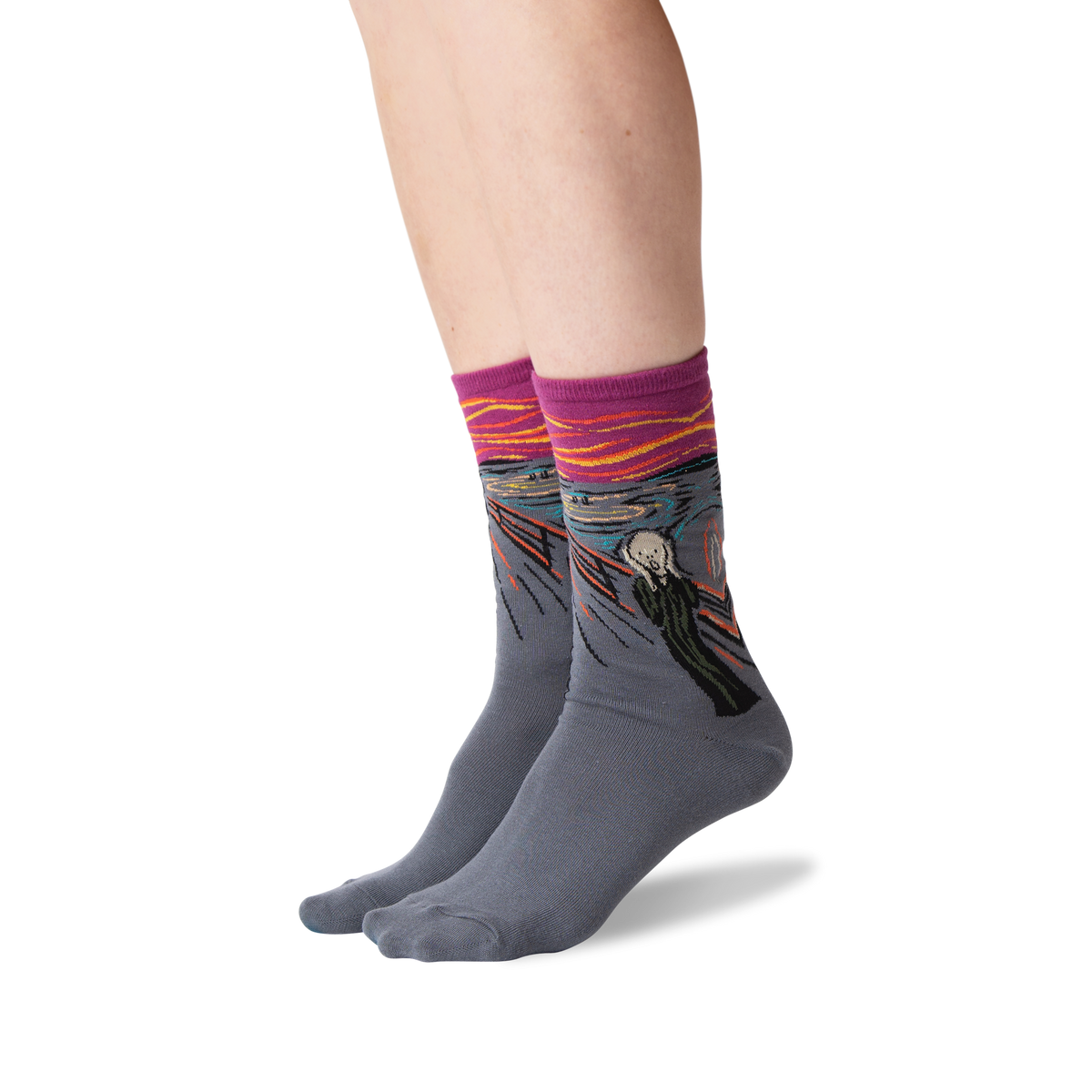 A pair of crew socks worn on a person's feet, featuring a gray base with a colorful print of Edvard Munch's 'The Scream' and a pink cuff.