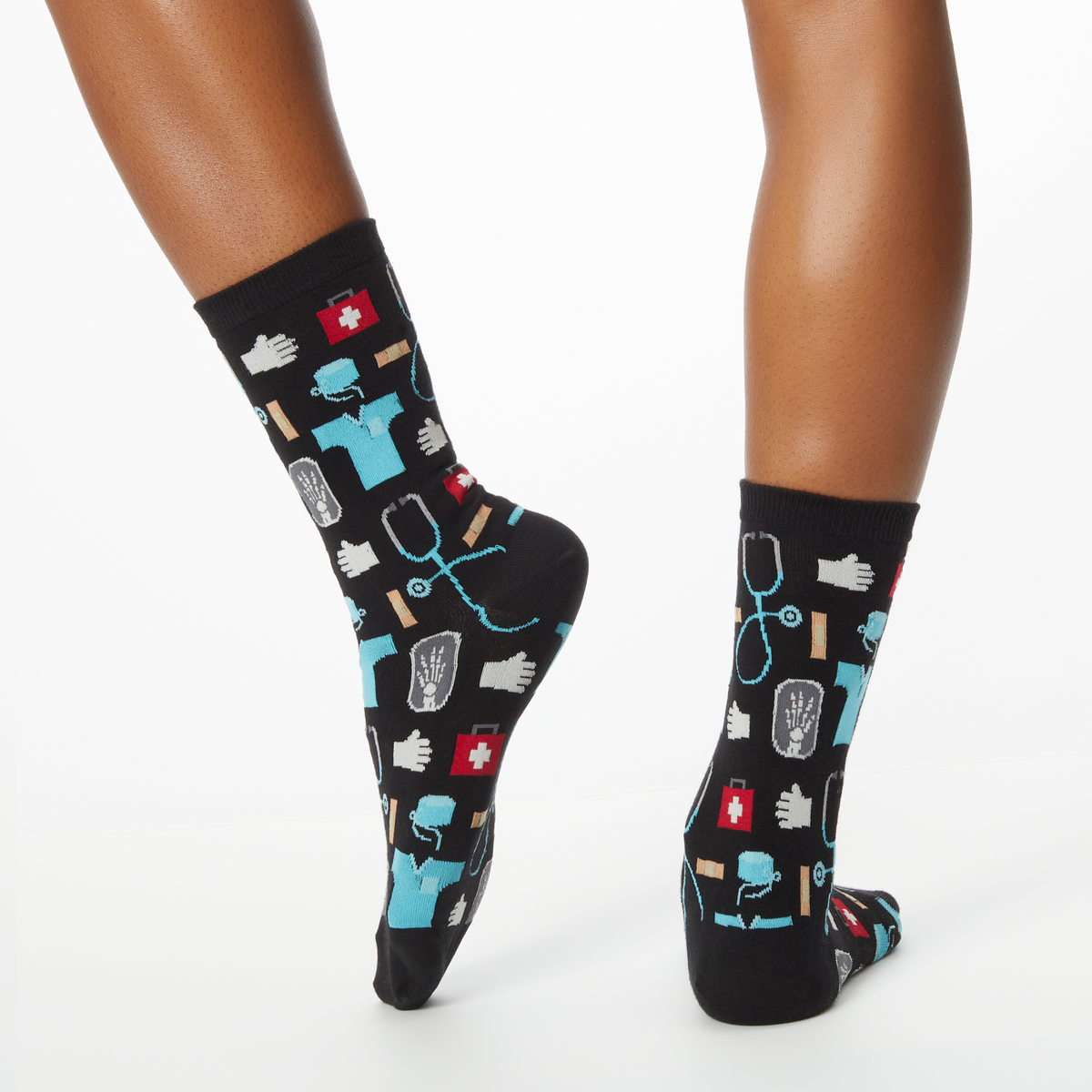 Woman wearing black socks with a repeat medical pattern