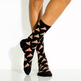 Black socks with pizza pattern worn by a woman on a white background
