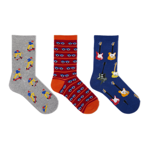 Three pairs of patterned crew socks displayed side by side on a plain white background. The left sock is heather gray with cartoon skateboarder prints.