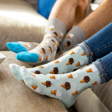 Person wearing socks with ice cream cone pattern on a couch