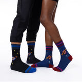 Two pairs of socks with space-themed designs on a white background