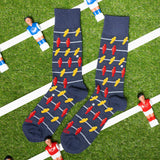 Pair of socks with foosball pattern on grass field thumbnail