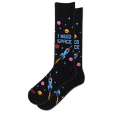 A pair of black crew socks with a colorful space-themed print featuring rockets, planets, stars, and the text 'I NEED SPACE'.