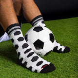 Person wearing black and white patterned socks with a soccer ball on grass thumbnail