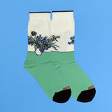 Green socks with floral 'Irises' design by Van Gogh on a blue background thumbnail
