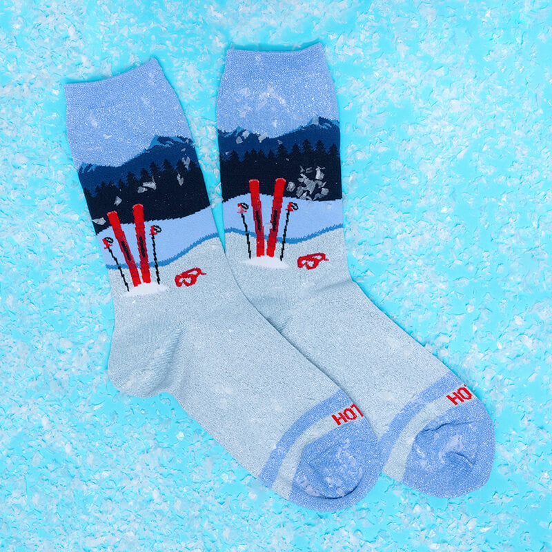 Pair of socks with ski design on a blue textured background