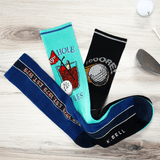 Three pairs of golf-themed socks on a wooden surface with a golf club in the background. thumbnail