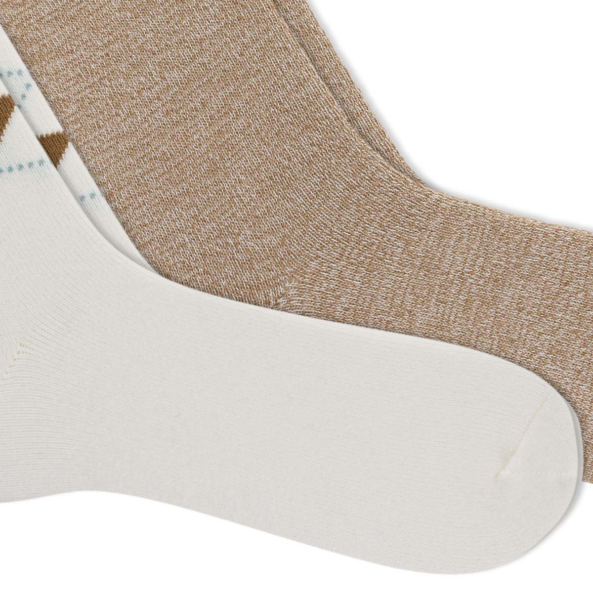 Two pairs of crew socks arranged diagonally on a white background, showing different colorways: one heathered tan pair and one white pair with a small brown and light blue argyle pattern.