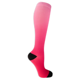Dr. Scholl's women's compression socks featuring a light to hot pink dip dye color and black accents at the heel and toe. thumbnail