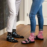 Two people wearing socks with medical and animal patterns on a wooden floor. thumbnail