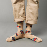 Beige socks with car pattern worn with beige pants on a gray background thumbnail