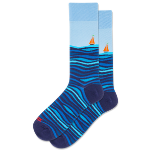 Blue and navy sock with wavy pattern and sailboat design on a white background