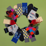 Assorted pairs of socks arranged in a circular pattern on a green background with decorative elements.