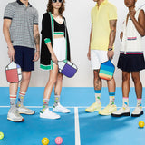 Four people standing on a pickleball court with colorful bags and socks. thumbnail