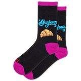 Black socks with pink accents, blue text, and croissant illustrations on a white background