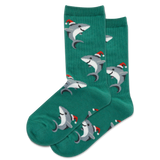 Two children sitting on a staircase holding gifts, wearing colorful Christmas socks with sharks, Santa and unicorns.