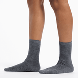 Gray socks worn by a person on a white background thumbnail