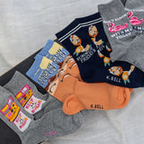 Collection of colorful socks with various designs and text on a textured surface thumbnail