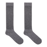 A pair of gray over the calf compression socks